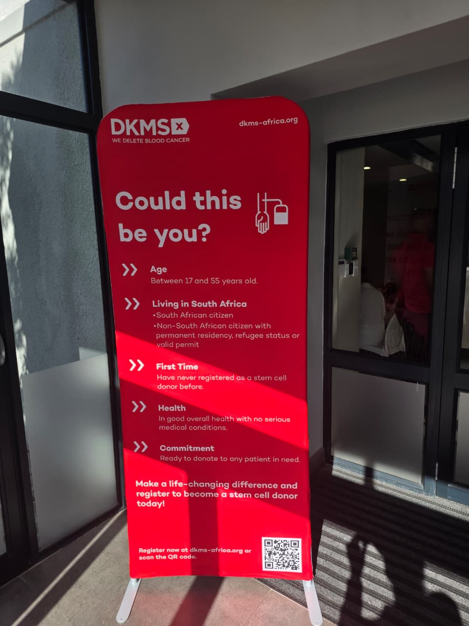 A DKMS Africa banner listing donor eligibility: ages 17 to 55, living in South Africa, in good health.
